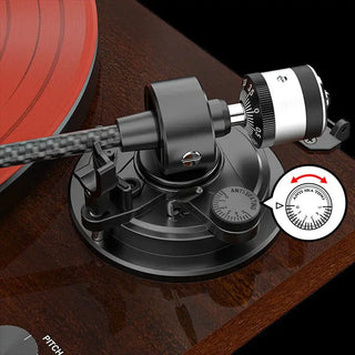 Turntable anti-skate adjustment knob and tonearm on a wooden record player