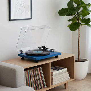 Modern blue Bluetooth turntable on wooden shelf with vinyl records in stylish living room