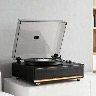 Modern all-in-one record player with built-in speakers on a white cabinet in a minimalist room