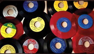 Vinyl records with colorful labels and red discs arranged on a flat surface