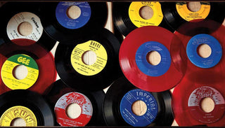 Vinyl records with colorful labels and red discs arranged on a flat surface