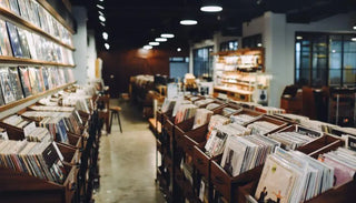 Vinyl records and albums displayed in a modern record store with wooden shelves