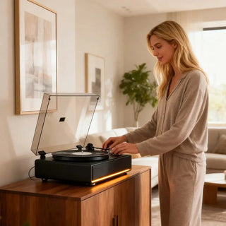 Woman using modern all-in-one record player on wooden cabinet in bright living room