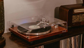 Retrolife HQKZ-006 turntable with dust cover on, playing vinyl record on wooden shelf