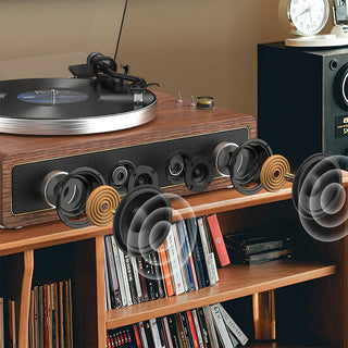 Retro wooden record player with exposed speakers on a shelf, vinyl and books below.