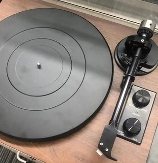 Close-up of a modern record player with wood finish and control knobs