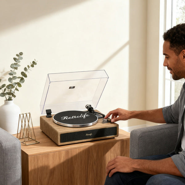 Man using Retrolife all-in-one turntable on wooden table in sunlit living room