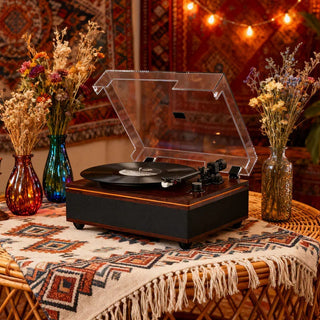 Vintage turntable with vinyl record on boho table, surrounded by dried flowers and rugs
