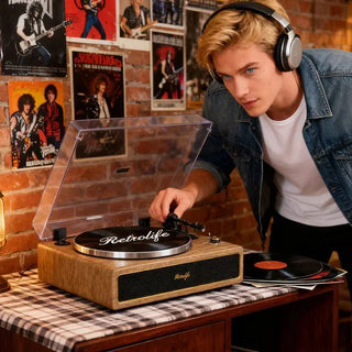 Man using Retrolife record player with headphones in a vintage music room with brick wall.