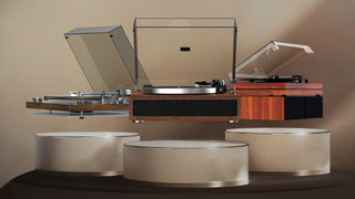 Three modern vinyl record players with dust covers on wooden platforms against a beige background