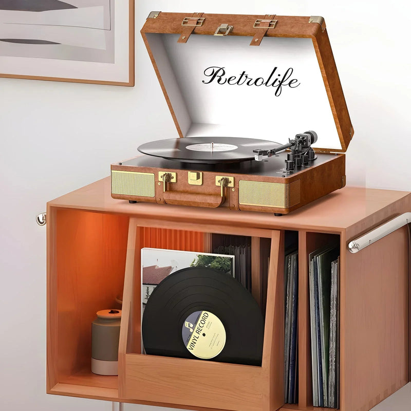 Vintage style suitcase record player on wooden shelf with vinyl records and modern decor